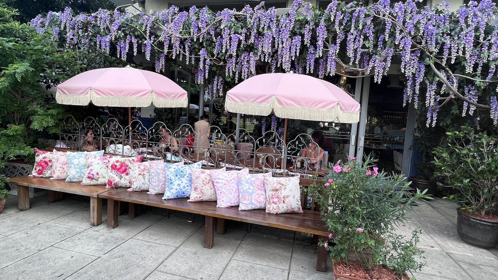 Garden cafe styled with wisteria and floral pillows